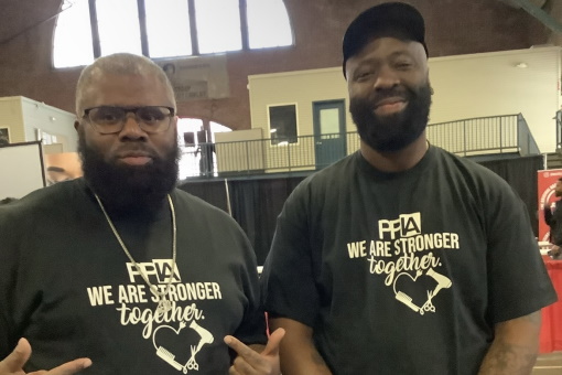 Two PPIA member barbers at a community event
